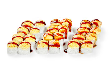 Delicious baked sushi rolls with cream cheese and sauce forming letter m on white background