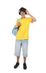 Fototapeta premium Teenage boy in headphones with backpack on white background