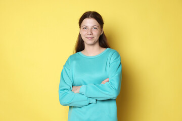 Portrait of teenage girl on yellow background