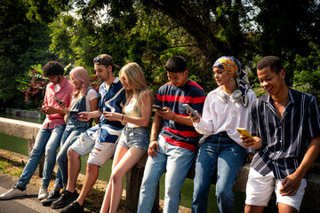 Group of multiethnic teenagers spending time outdoor and having fun