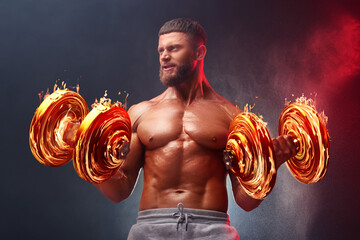 Bodybuilder exercising with flaming dumbbells in smoke against dark background