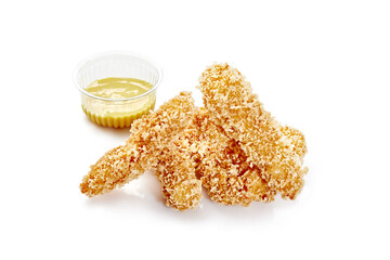 Breaded chicken strips with honey mustard dipping sauce on white background