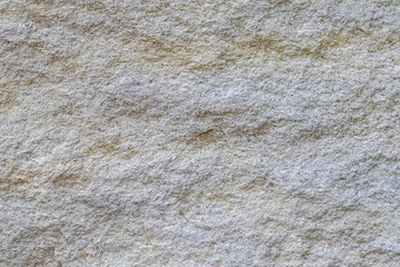 Light sandy rock texture with fine grain, creating a natural yet solid background with neutral tones