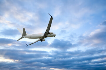 Airplane flying in beautiful blue sky with clouds