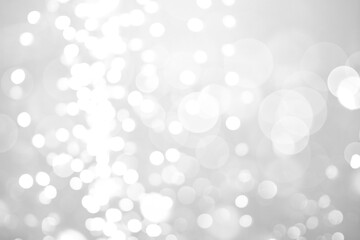 Blurred shiny silver background with sparkling glitter, bokeh effect