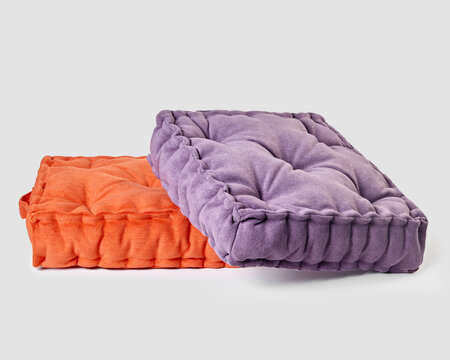 Two square floor cushions creating relaxing atmosphere