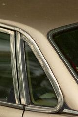 This image captures a close up view of a car window that features an elegant chrome trim, adding a...