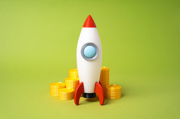 Rocket and money coins. Fundraising for a startup. Funding, angel investment. Business...
