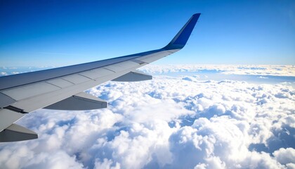 Obraz premium Airplane wing above clouds.View from airplane window a blue sky and clouds.
