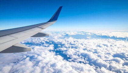 Obraz premium Airplane wing above clouds.View from airplane window a blue sky and clouds.