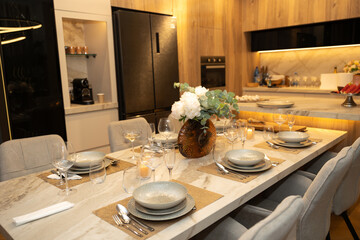 Elegant Dining Experience with Exquisite Table Setting Featuring Stylish Dinnerware and Modern Kitchen Ambience