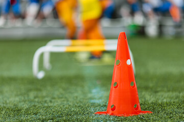 Training Cone on Sports Field for Youth Agility and Coordination Drills. Essential Equipment for Soccer, Football, and Athletic Practice