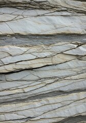 Detailed close up of layered sedimentary rock formations with fine cracks