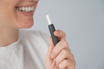 Woman smoking tobacco heating system. Electronic cigarette.