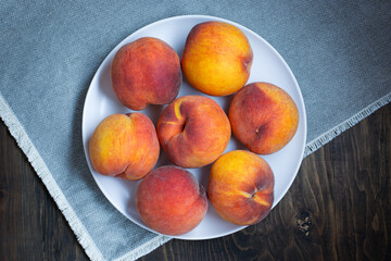 Perfect shape large peaches on a plate. Beautiful real peaches. 