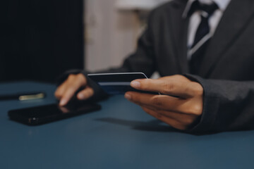 Online payment,businessman hands holding credit card and using  laptop for online shopping. Cyber Monday Concept