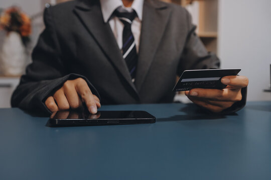 Online payment,businessman hands holding credit card and using  laptop for online shopping. Cyber Monday Concept - Powered by Adobe