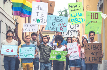Public demonstration on the street against global warming and pollution. Group of multiethnic...