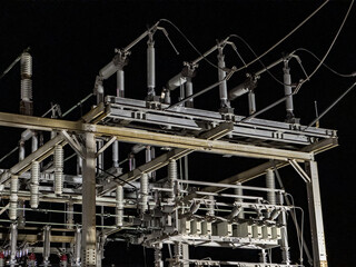 An electrical substation dominates the night sky