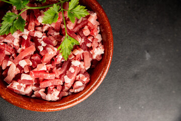 Bacon cubes smoked chopped meat small pieces fresh delicious gourmet food background on table rustic food top view copy space