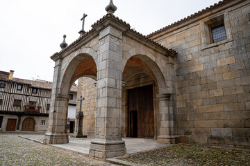 Fototapeta premium Historic Stone Church Facade with Wooden Doors