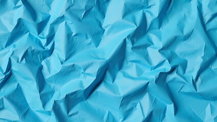 Obraz premium Abstract blue background, a crumpled texture of paper, conveying a sense of disorder, Texture background of crumpled light blue paper with wrinkles and dents