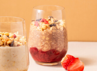Strawberry Oatly Chocolate glass Overnight Oats with Berries and Granola side view of breakfast meal