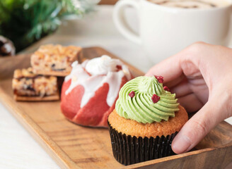 Festive Christmas Tree Cupcake with Green Frosting and Holiday Treats on Tray side view of seasonal bakery