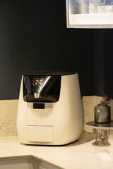 Sleek countertop water-cooler dispenser in luxury marble kitchen interior