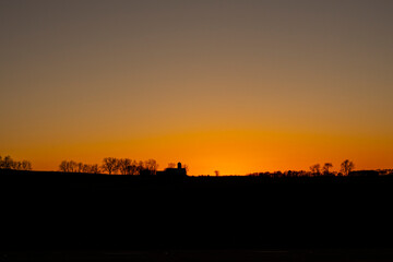 sunset over a farm 