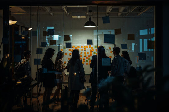Team Collaboration on Creative Ideas, Business brainstorming session on whiteboard with sticky notes behind glass window, focus on teamwork