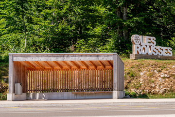 Wooden Bus Shelter and Les Rousses Sign. Les Rousses, Jura, France.