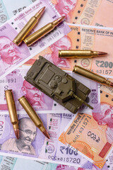 Money and flag of India with ammunition and tank as a concept of weapons for war. India and weapons