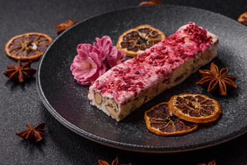 Nougat or white caramel with hazelnuts and strawberry pieces. White nougat