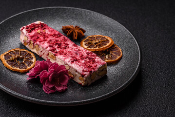 Nougat or white caramel with hazelnuts and strawberry pieces. White nougat