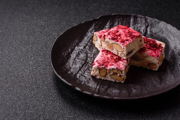 Nougat or white caramel with hazelnuts and strawberry pieces. White nougat