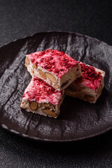 Nougat or white caramel with hazelnuts and strawberry pieces. White nougat