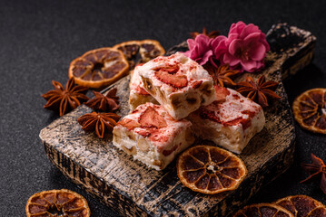 Nougat or white caramel with hazelnuts and strawberry pieces. White nougat