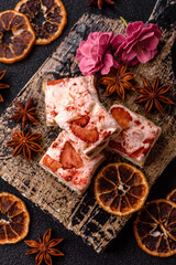 Nougat or white caramel with hazelnuts and strawberry pieces. White nougat