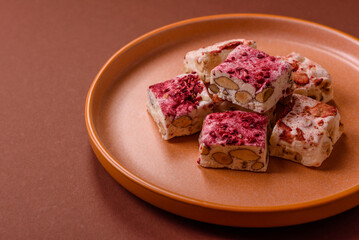 Nougat or white caramel with hazelnuts and strawberry pieces. White nougat