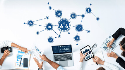 This image depicts a collaborative business meeting where professionals utilize digital tools for data visualization, enhancing strategic planning and productivity in a modern office. Amity