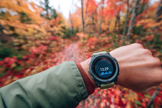 Exploring a vibrant autumn trail while checking fitness stats on a smartwatch