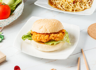 Crispy Chicken Fillet Burger on Sesame Bun with Fresh Lettuce in plate side view of hong kong food