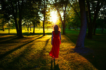 A woman in red go to the sunlight
