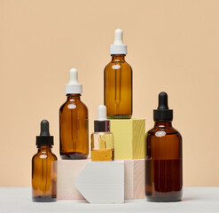 Various glass bottles with pipettes containing cosmetic serums or oils.