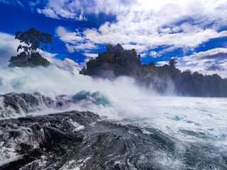 Wild spray at the bottom of the Rhine Falls – dramatically captured with rising mist and roaring...