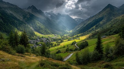 Fototapeta premium A lush mountain valley unfolds, illuminated by rays of sunlight piercing through dark clouds. A peaceful village nestles among verdant hills, showcasing nature's beauty in every direction.