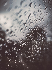  Raindrops on glass with bokeh-style background – warm light reflections.
