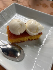 Revani dessert on wood background. Traditional Ramadan dessert. Revani dessert with pistachio and coconut