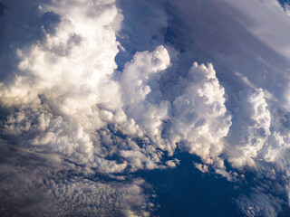 Massive cloud towers rise into the sky – spectacularly captured from an airplane.